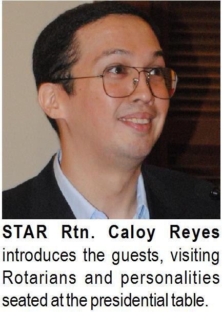 Rtn. Caloy Reyes introduces the guests, visiting Rotarians and personalities seated at the presidential table.