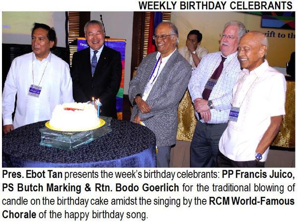 Pres. Ebot Tan presents the week's birthday celebrants: PP Francis Juico, PS Butch Marking & Rtn. Bodo Goerlich for the traditional blowing of candle on the birthday cake amidst the singing by the RCM World-Famous Chorale of the happy birthday song.