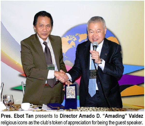 Pres. Ebot Tan presents to Director Amado D. "Amading" Valdez religious icons as the club's token of appreciation for being the guest speaker.
