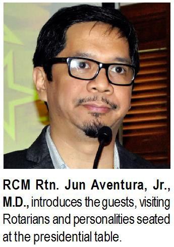 RCM Rtn. Jun Aventura, Jr., M.D., introduces the guests, visiting Rotarians and personalities seated at the presidential table.