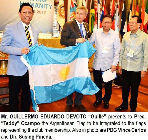 Mr. GUILLERMO EDUARDO DEVOTO "Guille" presents to Pres. "Teddy" Ocampo the Argentinean Flag to be integrated to the flags representing the club membership. Also in photo are PDG Vince Carlos and Dir. Susing Pineda.