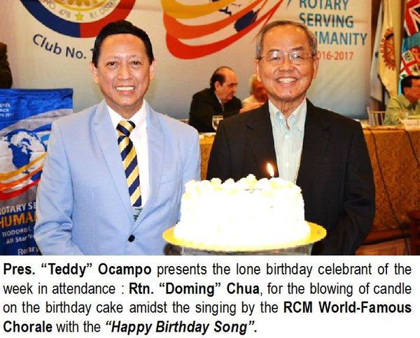 Pres. "Teddy" Ocampo presents the lone birthday celebrant of the week in attendance: Rtn. "Doming" Chua, for the blowing of candle on the birthday cake amidst the singing by the RCM World-Famous Chorale with the "Happy Birthday Song".