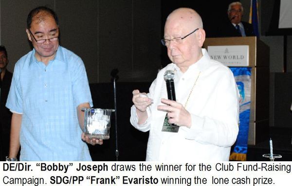 DE/Dir. “Bobby” Joseph draws the winner for the Club Fund-Raising Campaign. SDG/PP “Frank” Evaristo winning the lone cash prize.