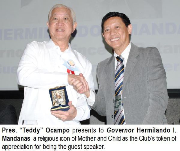 Pres. “Teddy” Ocampo presents to Governor Hermilando I. Mandanas a religious icon of Mother and Child as the Club's token of appreciation for being the guest speaker.