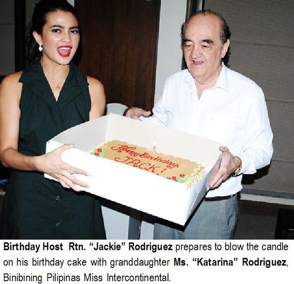 Birthday Host Rtn. “Jackie” Rodriguez prepares to blow the candle on his birthday cake with granddaughter Ms. “Katarina” Rodriguez, Binibining Pilipinas Miss Intercontinental.