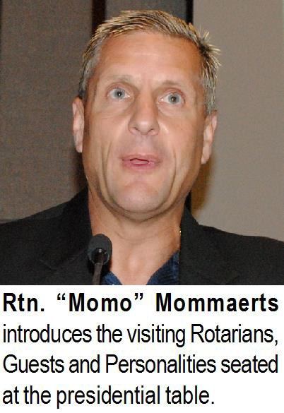 Rtn. “Momo” Mommaerts introduces the visiting Rotarians, Guests and Personalities seated at the presidential table.