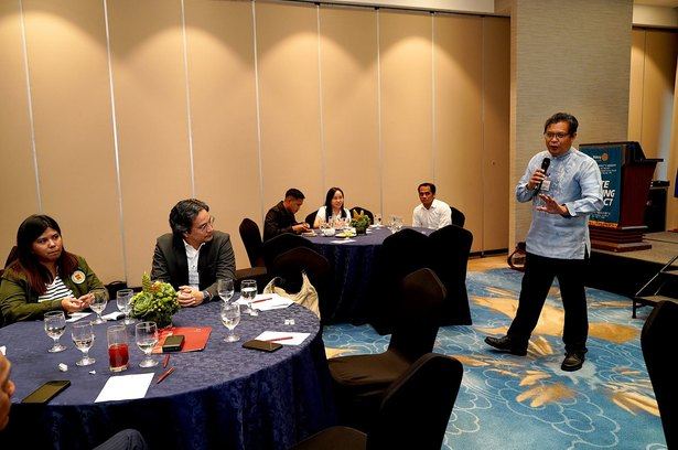 Dr. Raymund Narag steps away from the lectern to engage participants directly, turning the forum's central question into a conversation around the room: how should we measure policing that truly serves the public?