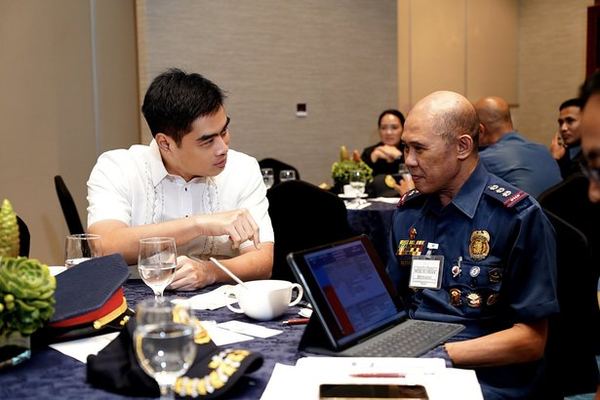 President Reginald Yu confers with Police Colonel Florian Reynado during the September 21 policy dialogue. Their exchange reflects the forum's purpose: bringing civic and police perspectives together to develop measures of service that make a difference in people's lives.