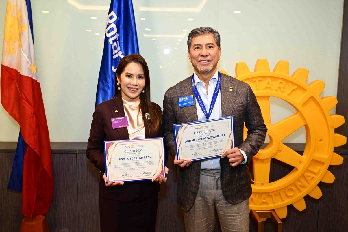 DGN Hermie Esguerra and PDG Joyce Michelle Socorro Ambray with their certificates of completion