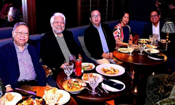 Settled comfortably around a generous spread, our Manila Rotarians and their company share a cheerful moment during "Timeless Duets". The relaxed smiles capture what made this new fellowship experience so appealing: a welcoming setting, delicious food subsidized by our Fellowship Committee, and beloved classics enjoyed among friends.