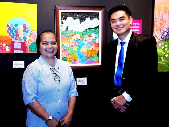 President Reginald Yu with Sr. Martha Gamolo, DC, Administrator of Hospicio de San Jose, surrounded by the colorful works of the Angels of Rendu at Beyond Limits.