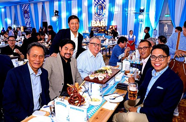 Our table at Solaire became a welcoming corner of the Oktoberfest celebration, where conversation flowed easily and smiles arrived without prompting. Beneath Bavarian banners and blue lighting, we paused for this photograph, preserving a moment of companionship amid the ballroom's bustle.