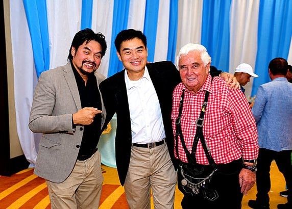Our smiles and an arm around a shoulder captured the easy affection that makes fellowship memorable. Against Solaire's blue-and-white curtains, traditional Bavarian attire mingled comfortably with jackets and smiles, reflecting the evening's welcoming spirit.