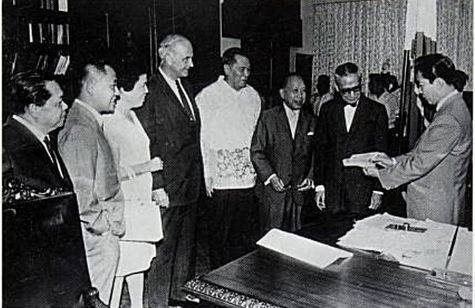 A historic moment in Philippine economic diplomacy: Alfonso Calalang, Governor of the Philippine Central Bank; Carlos P. Romulo, Secretary of Foreign Affairs; Eduardo Romualdez, Secretary of Finance; James Wilson, U.S. Chargé d’Affaires; and Jose de Venecia Jr. present to President Ferdinand Marcos the first “lipstick” U.S. dollar checks — distinctive instruments bearing red overprints and cashable only in Philippine pesos. 

This landmark presentation inaugurated the country’s first formal U.S. dollar remittance mechanism, laying the groundwork for a transformative inflow of foreign exchange. The initiative would prove pivotal in strengthening external reserves, stabilizing the economy, and institutionalizing overseas remittances — an early milestone in a system that would later become a vital pillar of Philippine economic resilience.